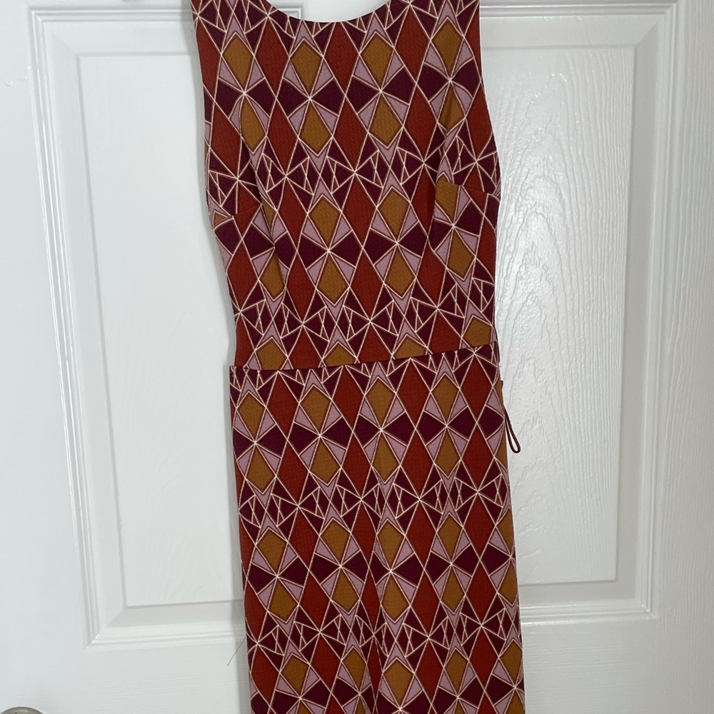 Mini dress with cut out of sides. Colors are tan, purple, brown
